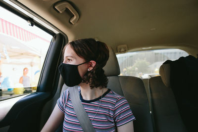 Portrait of woman sitting in car