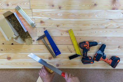 High angle view of man working on wooden floor