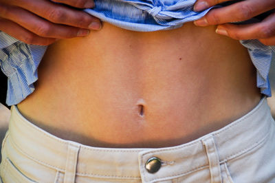 Midsection of woman showing belly