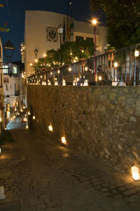 Illuminated street lights in city at night