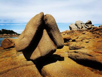 View of rock formation at beach against sky