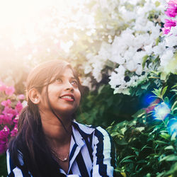 Portrait of a smiling young woman under the sun