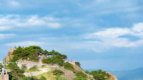 Scenic view of mountain by sea against sky