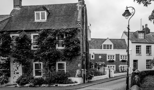 Houses in town against sky