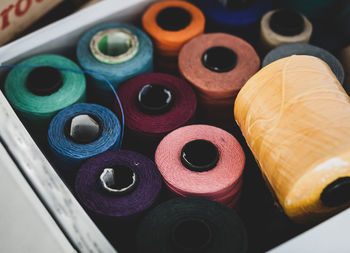 High angle view of multi colored thread in spools