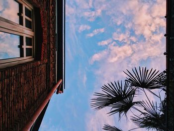 Low angle view of building against cloudy sky