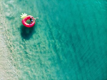 High angle view of woman with inflatable ring floating on sea