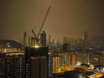 Illuminated cityscape against sky at night