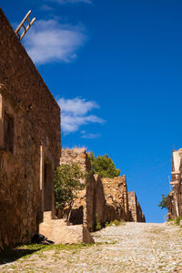 Old ruin building against blue sky