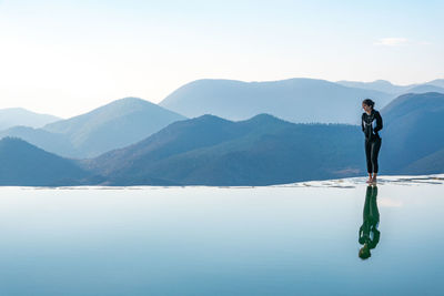 Man standing in mountains against sky