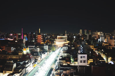 High angle view of illuminated buildings against sky at night