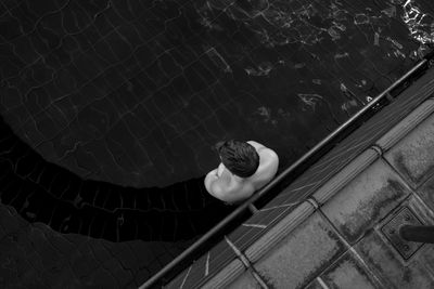 Directly above shot of man standing in swimming pool
