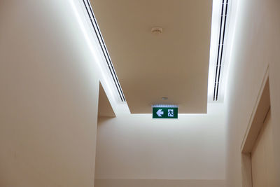 Low angle view of illuminated sign on wall