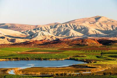 Scenic view of lake with mountain range in the background