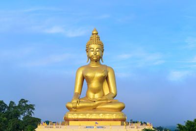 Low angle view of statue against blue sky