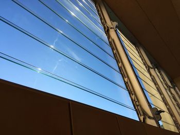 Low angle view of cables against blue sky