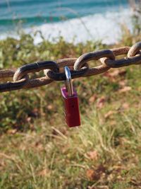 Close-up of padlock on chain against sky