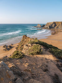 Scenic view of beach against clear sky