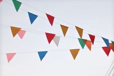 Low angle view of flags against clear sky