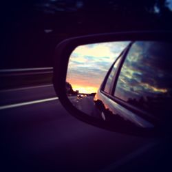 Reflection of car on road at sunset