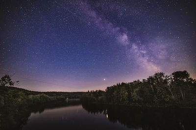 Scenic view of lake against sky at night