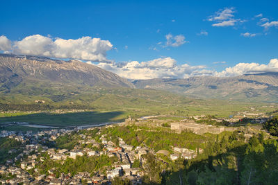 Aerial view of landscape and buildings against sky