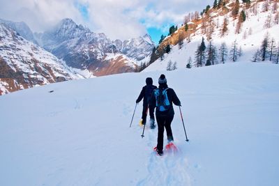 People walking on snow covered mountain