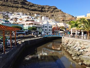 Bridge over canal amidst buildings in town