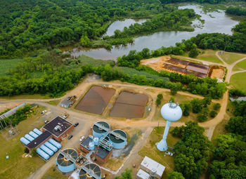 High angle view of buildings and trees on field