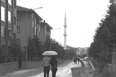 Low angle view of people walking on road