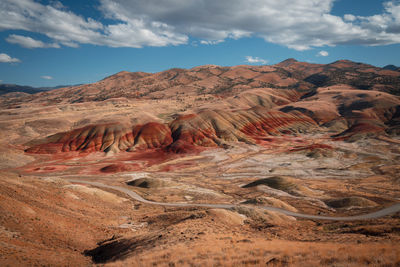 The painted hills in oregon. pretty unique and colorful mountain with red stripes on it.