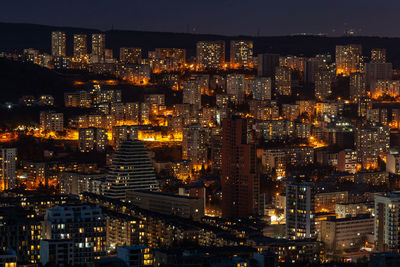 Illuminated modern buildings in city at night