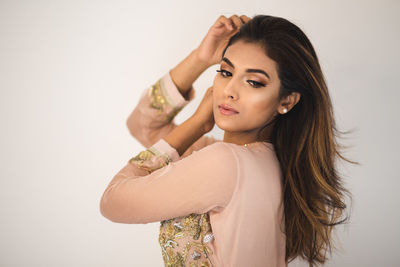 Portrait of a beautiful young woman over white background