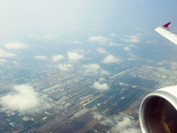 Aerial view of cityscape and airplane wing