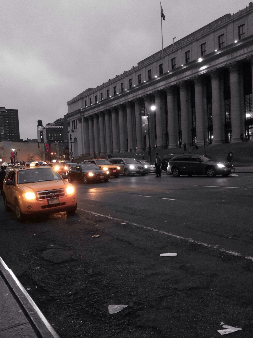 transportation, building exterior, architecture, car, built structure, street, land vehicle, road, city, mode of transport, road marking, sky, city street, street light, illuminated, city life, travel, outdoors, traffic, on the move