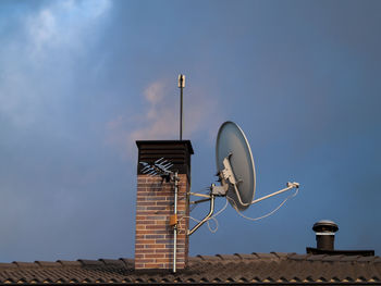 Low angle view of communications tower against sky