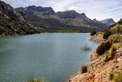 Scenic view of lake and mountains against sky