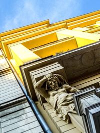 Low angle view of statue against building