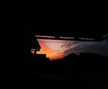 Low angle view of silhouette buildings against sky at night