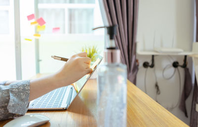 Woman holding umbrella on table at home