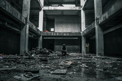 Man sitting in abandoned building