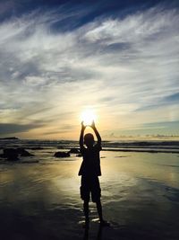 Rear view of man standing on beach