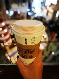 Close-up of hand holding coffee cup