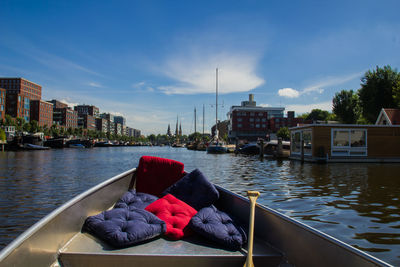 Boats in river with buildings in background