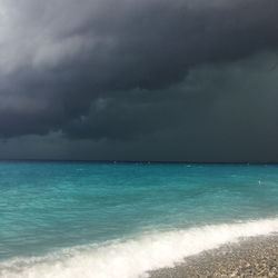 Scenic view of sea against storm clouds
