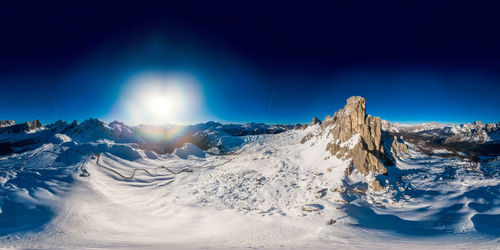 360 panoramic view of ra gusela -passo giau- over a blue sky, near cortina d'ampezzo, italy