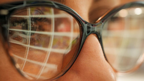 Pc screen reflection on woman eyeglasses. 