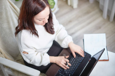 Young woman using laptop at home