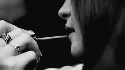 Close-up of woman holding cigarette