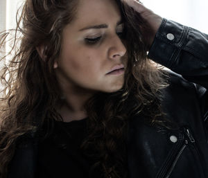 Close-up of mid adult woman wearing leather jacket